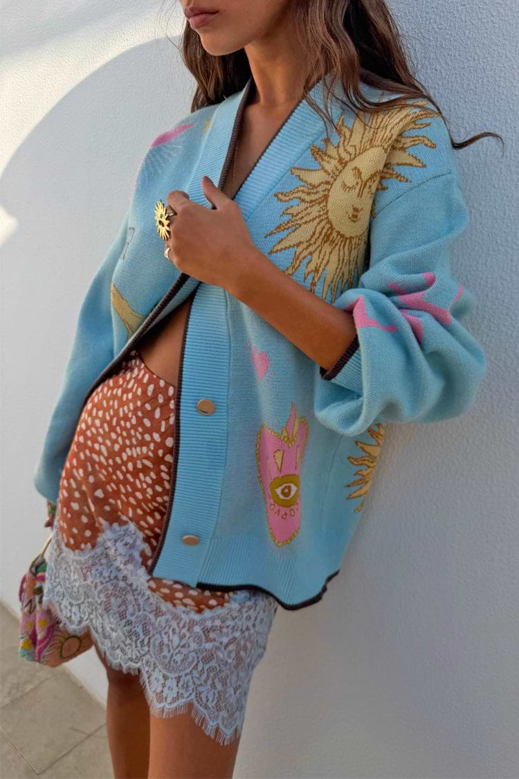 Aqua v-neck cardigan with sun and moon pattern.