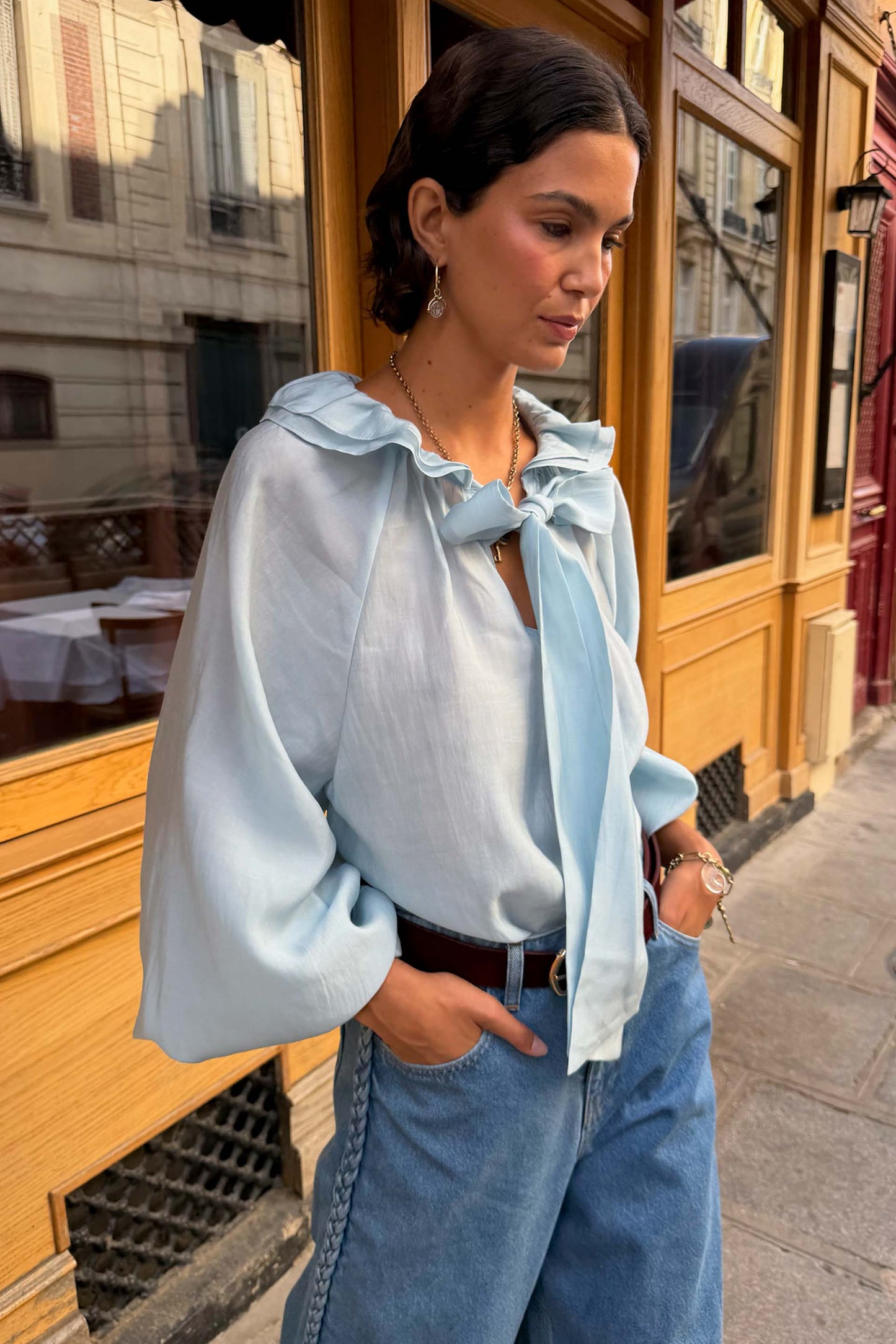 Ice blue ruffle neck blouse with balloon sleeves.