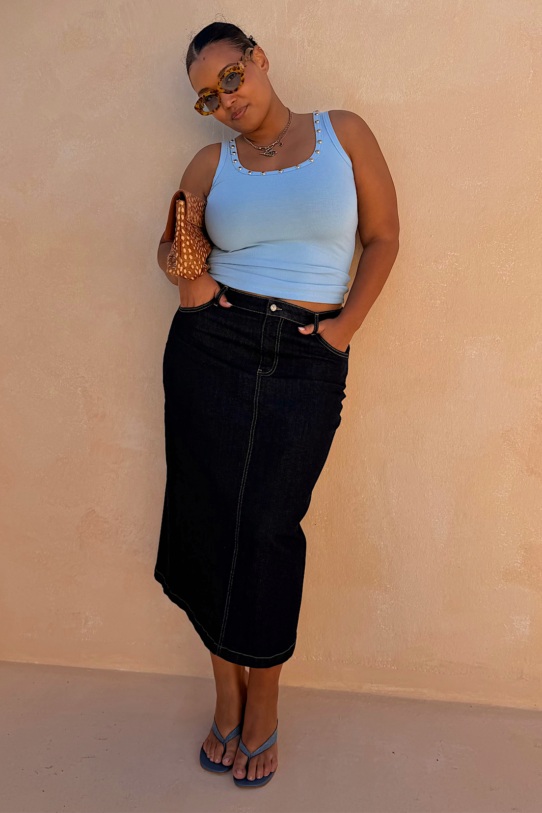 Black midi length denim pencil skirt.