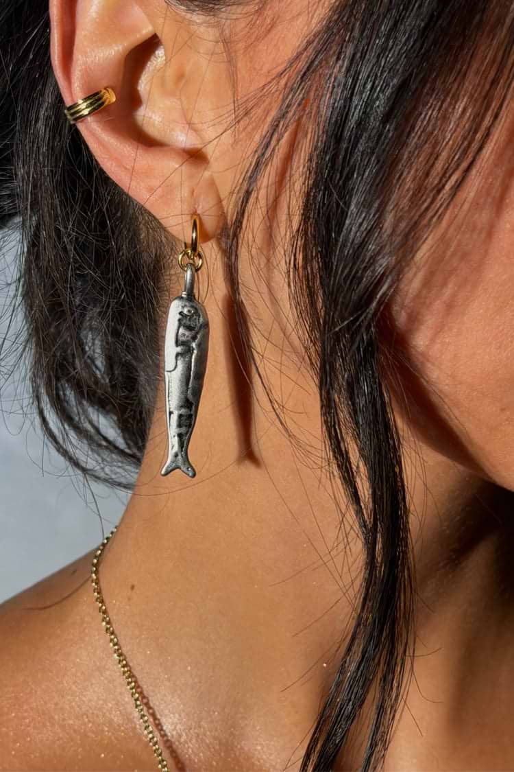 Silver coloured fish earrings.
