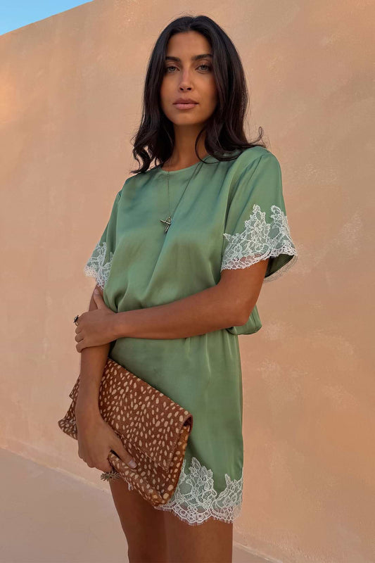 Sage green satin mini dress with lace trim.