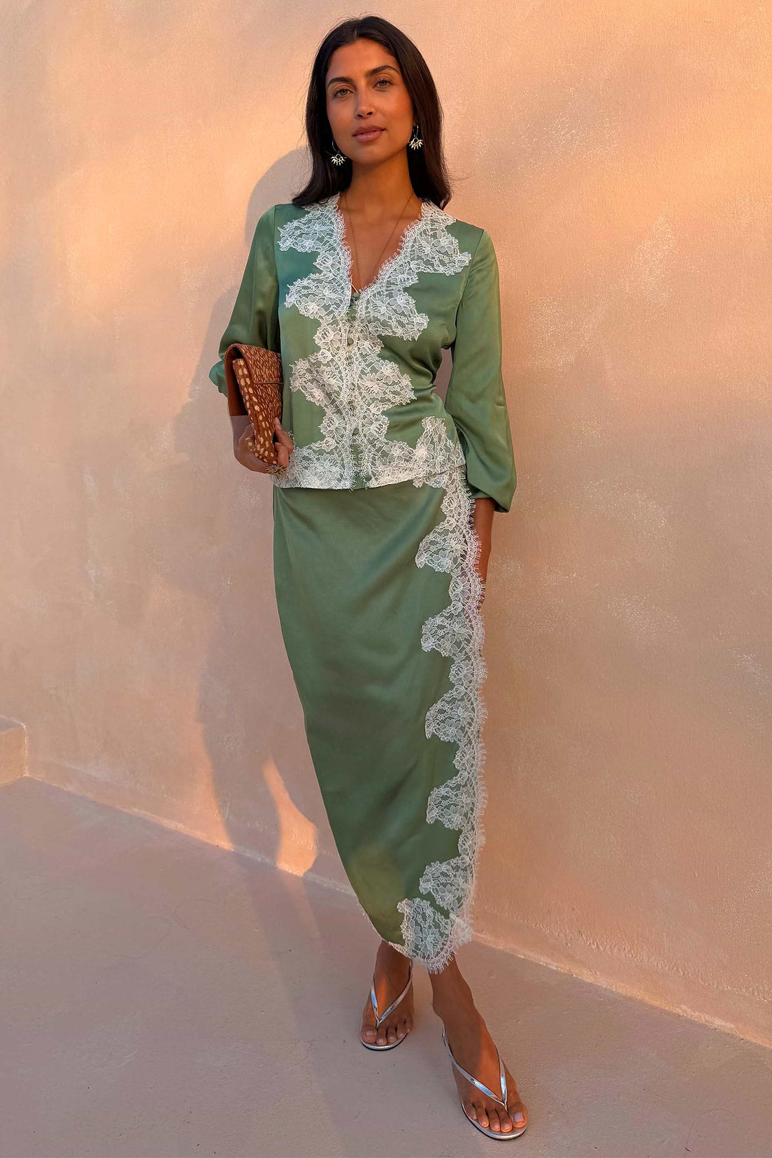 Sage green satin midi wrap skirt with lace trim.