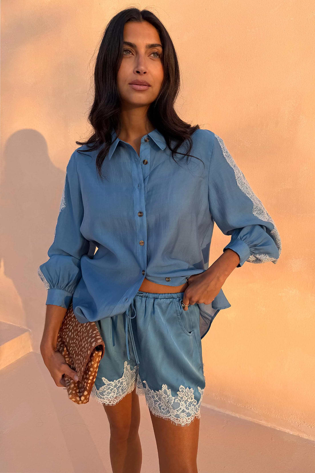 Light blue satin shorts with lace trim.