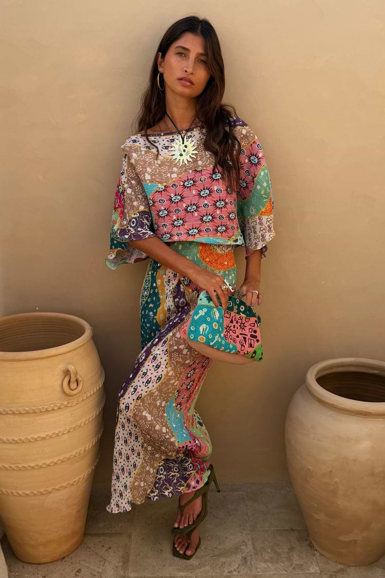 Multi-colour patchwork print midi dress with wide sleeves, mixed geometric and floral patterns, and relaxed flowing silhouette