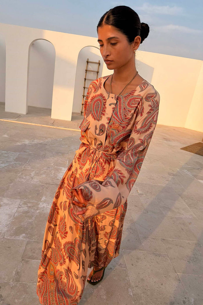 Long-sleeved paisley top in beige, rust and cinnamon tones.