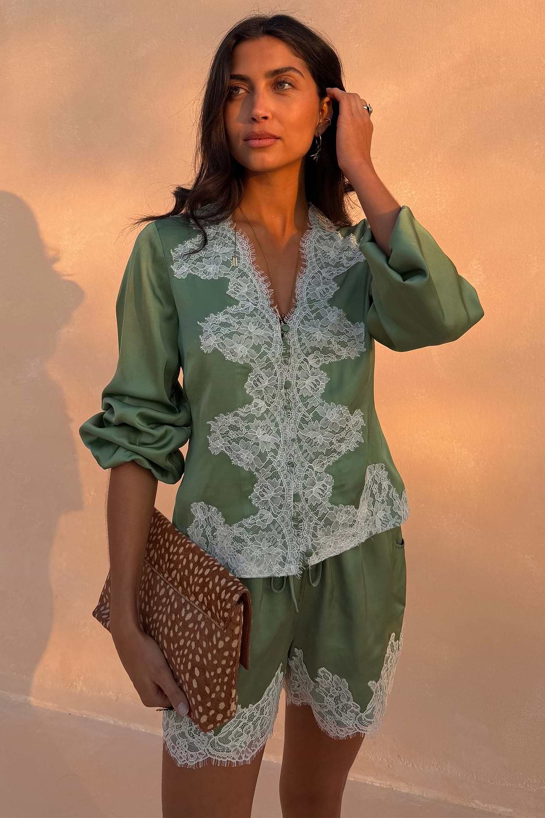 Sage green satin blouse with lace trim.