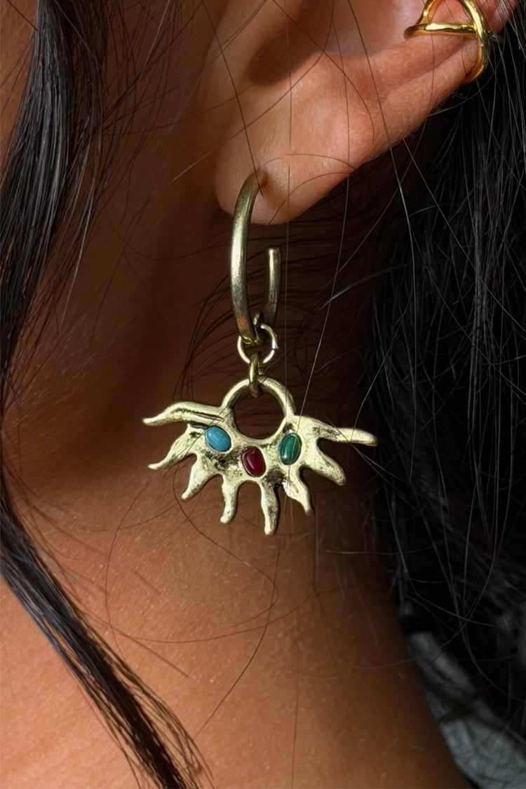 Antique gold finish sun earrings with gemstones.