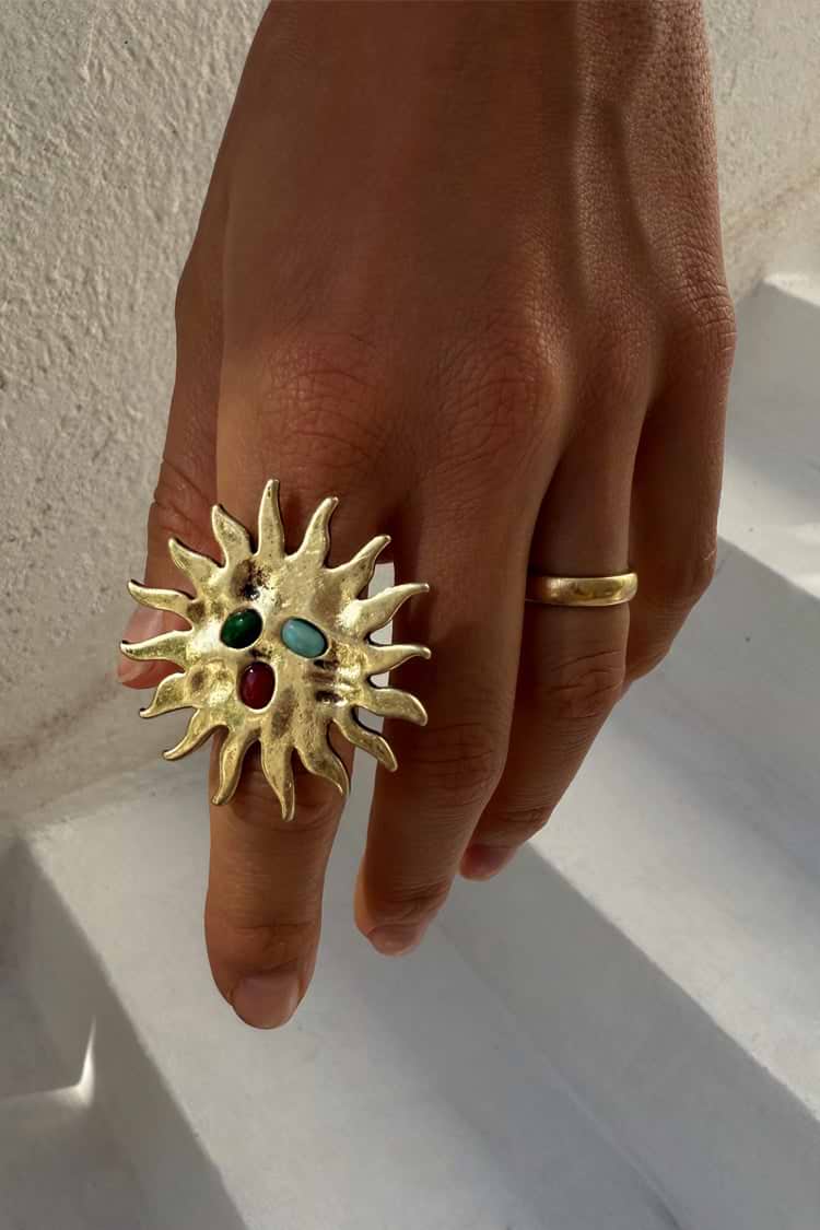 Brass sun shaped ring with gemstones.