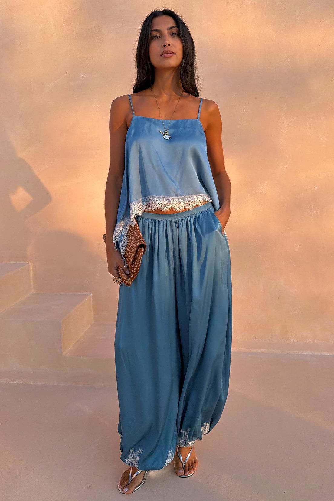 Light blue satin balloon leg trousers with lace trim.