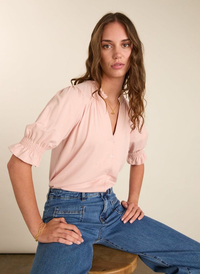 Powder pink short sleeve blouse with pie-crust collar.