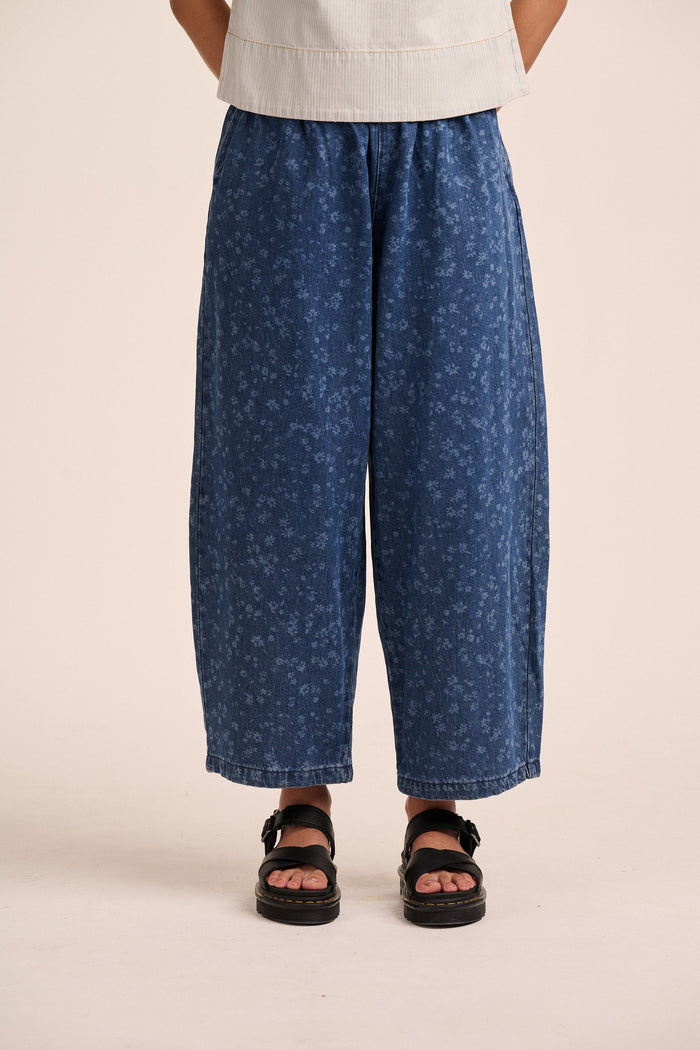 Mid wash blue floral denim barrel leg jeans.