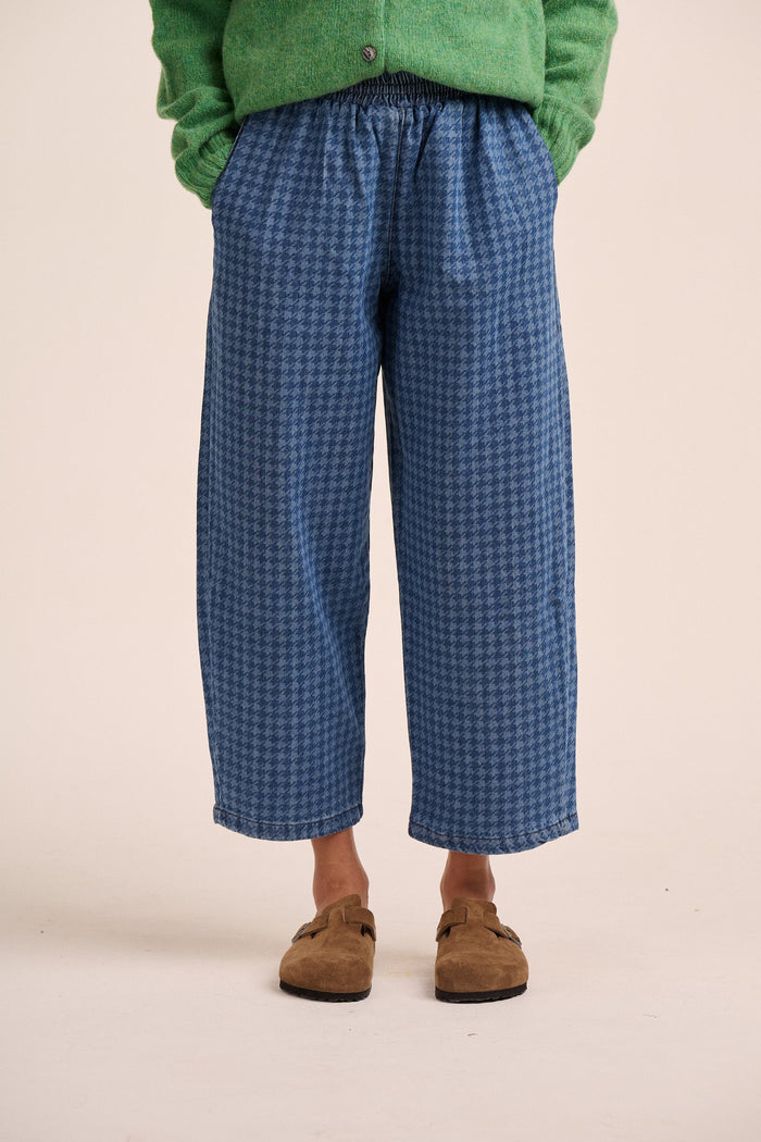 Houndstooth check mid wash denim jeans.