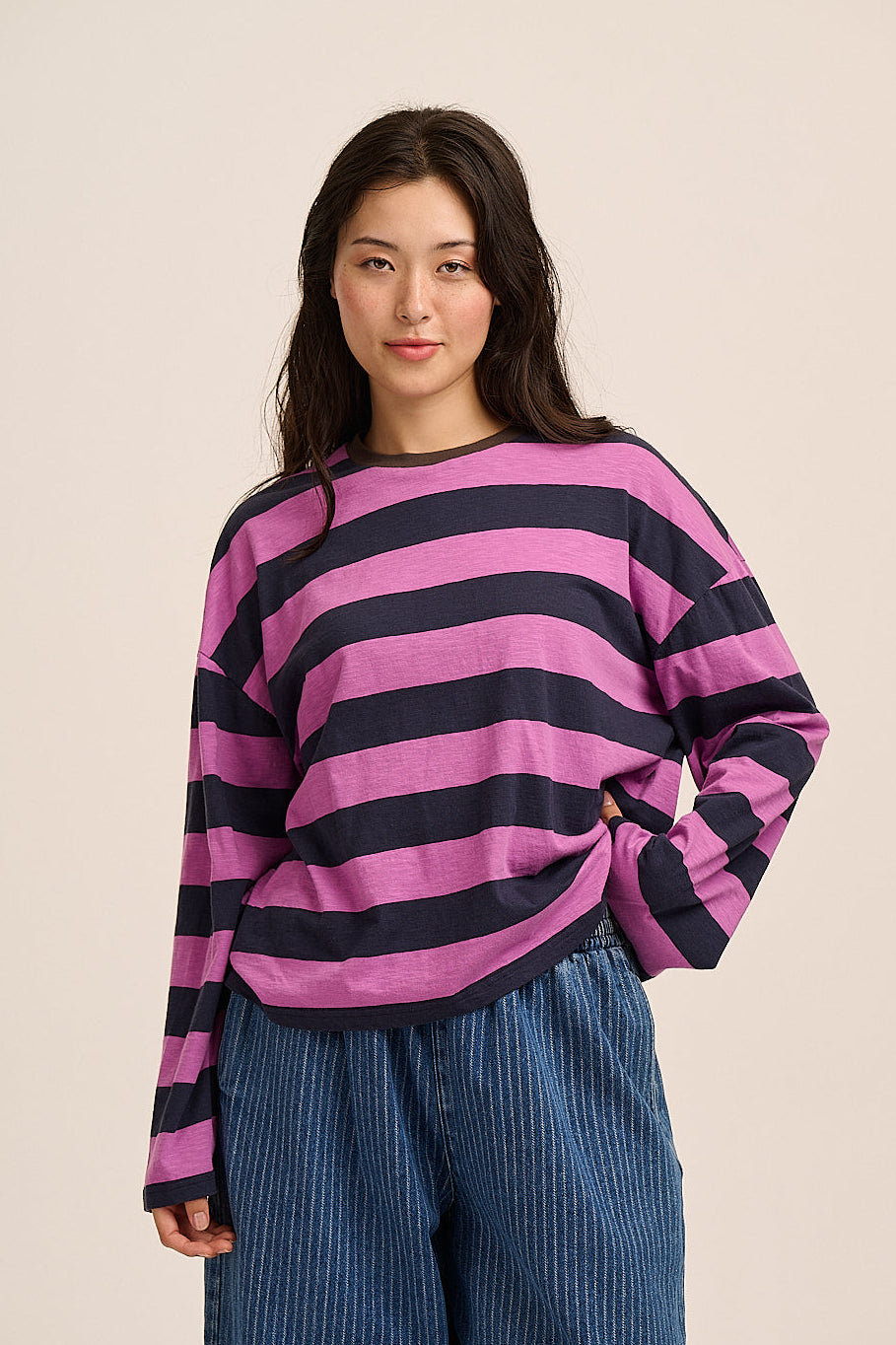 Woman wears wide stripe magenta and navy long sleeve t-shirt.