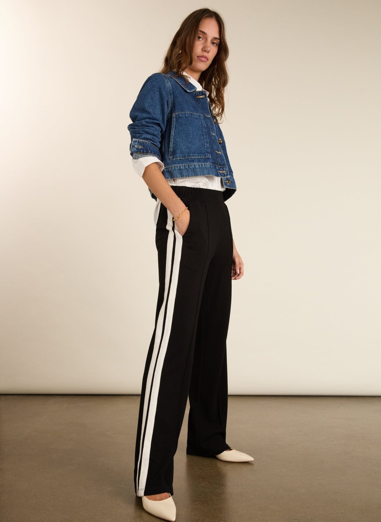 Black trousers with cream side stripe.