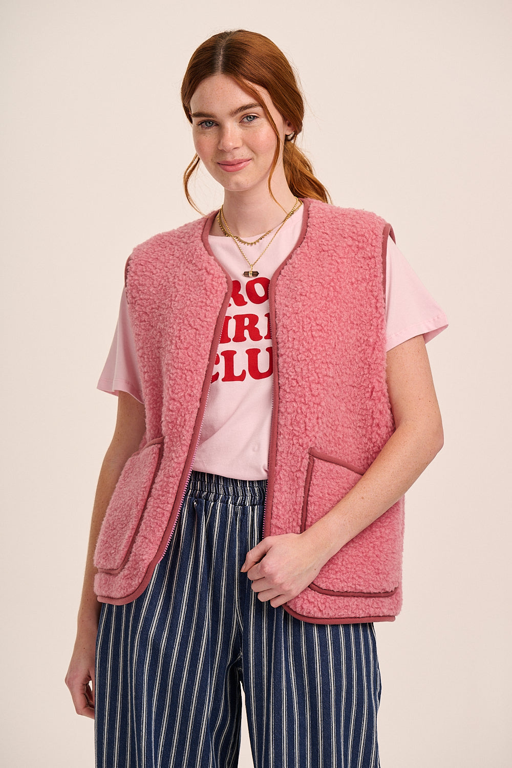 Pink fleece borg gilet with sleeveless design, zip front, patch pockets, and soft textured finish.