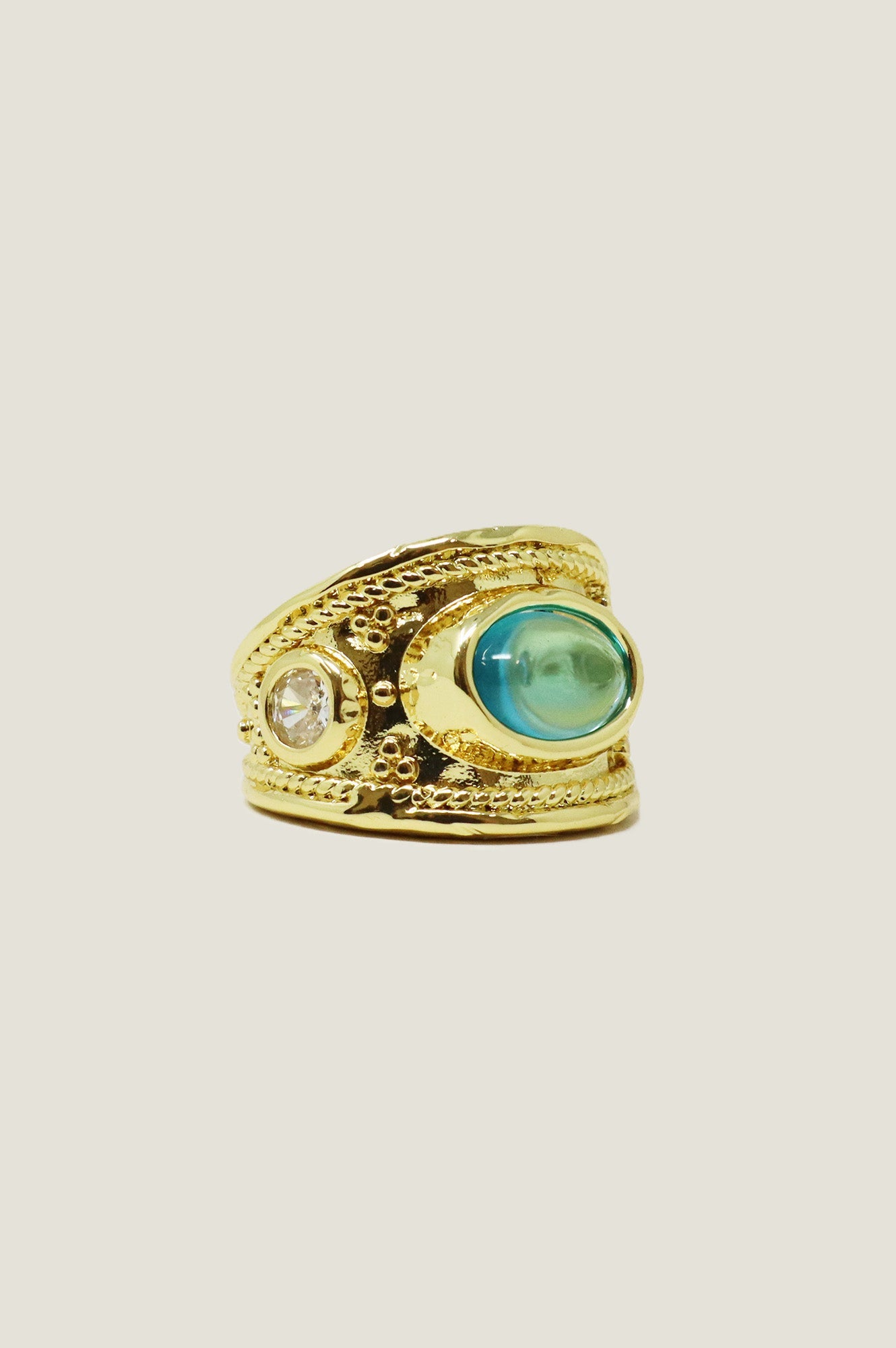 Gold chunky ring with turquoise and diamante gemstones.