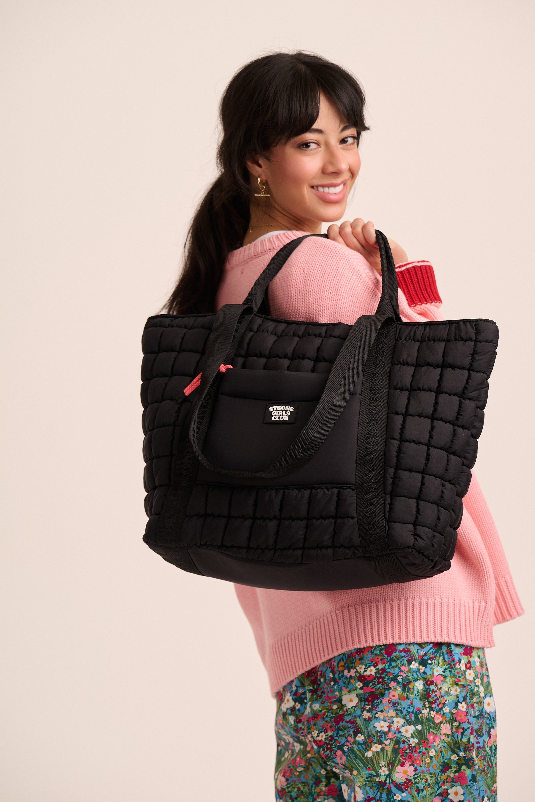 Quilted black tote bag by MuthaHood UK with Strong Girls Club logo.