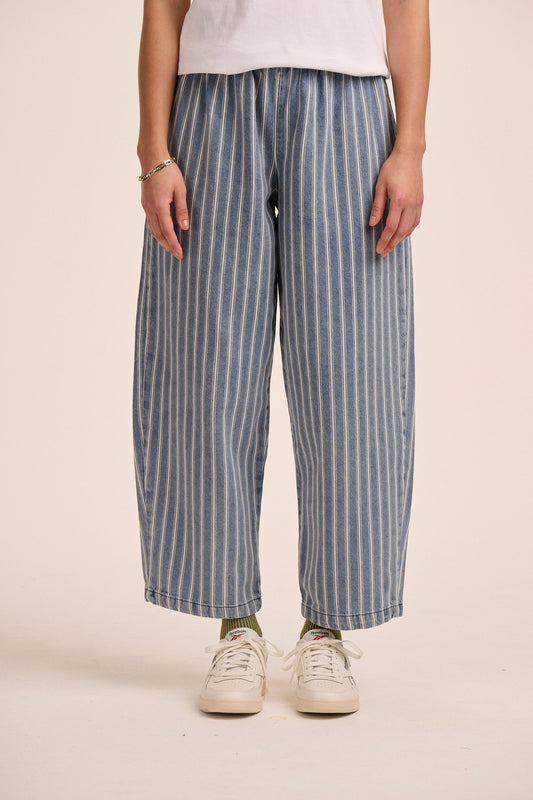 Light wash striped denim barrel leg jeans.
