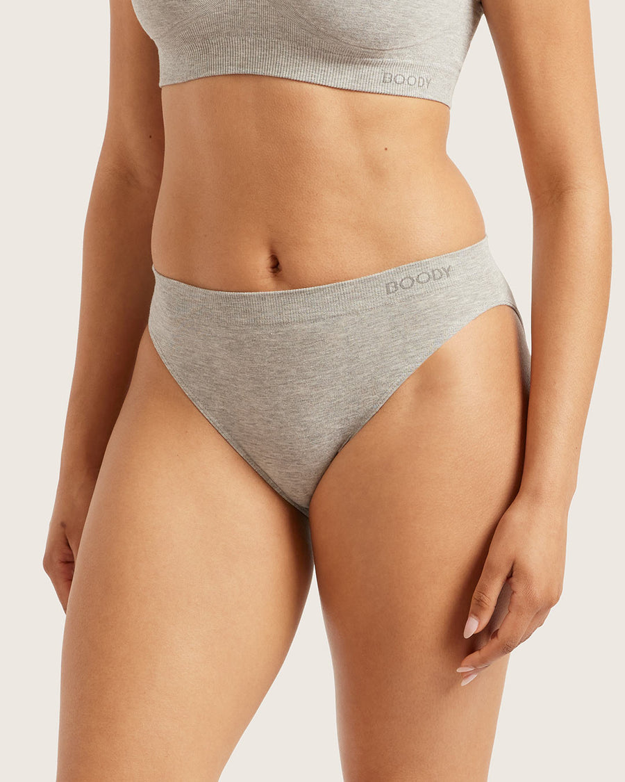 A close-up of a model wearing light heather gray high-waisted briefs and a matching ribbed crop top. The brand name 'BOOBY' is printed on the waistband of the briefs.