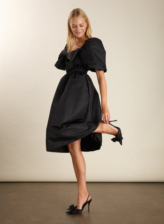 Black recycled polyester dress with puff sleeves and bow.