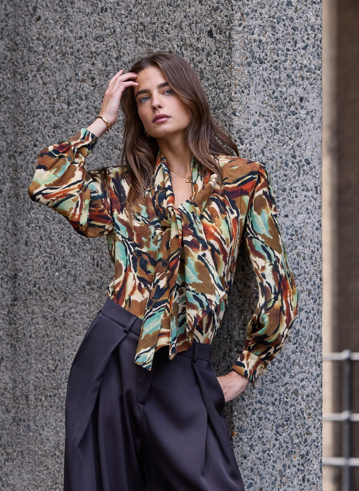 Abstract tie-neck blouse in brown and green tones.