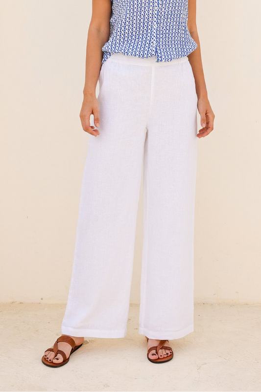 White wide-leg linen trousers with elasticated waistband and relaxed fit.