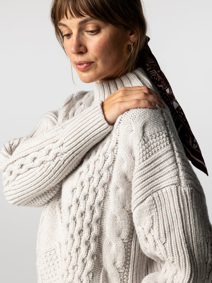 Dove grey cable knit high neck jumper.